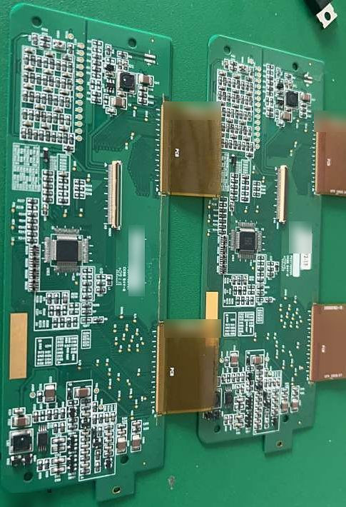 Two long assembled circuit boards with QFP chips and flexible connector tabs
