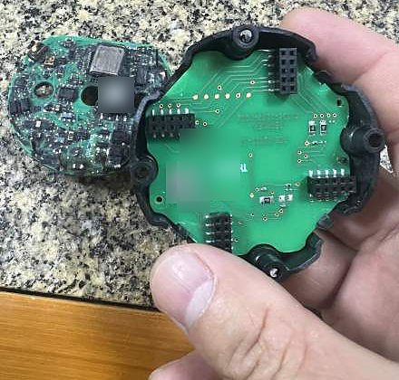 Two round circuit boards, one held in its black plastic housing